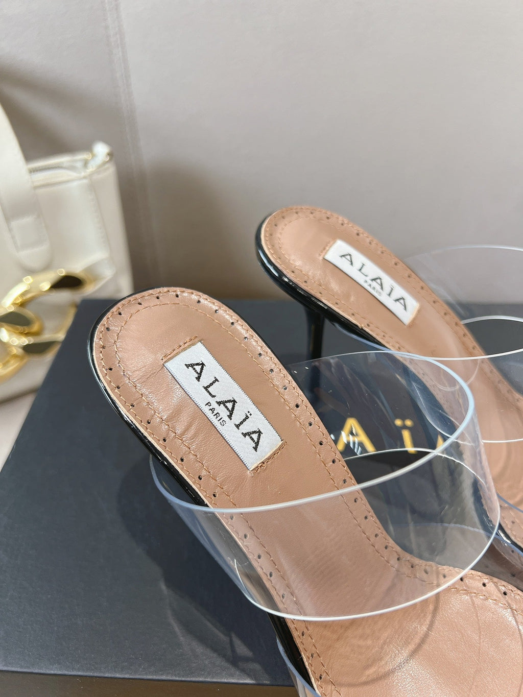 ALAIA HIGH MULES IN BLACK PATENT CALFSKIN AND FILM