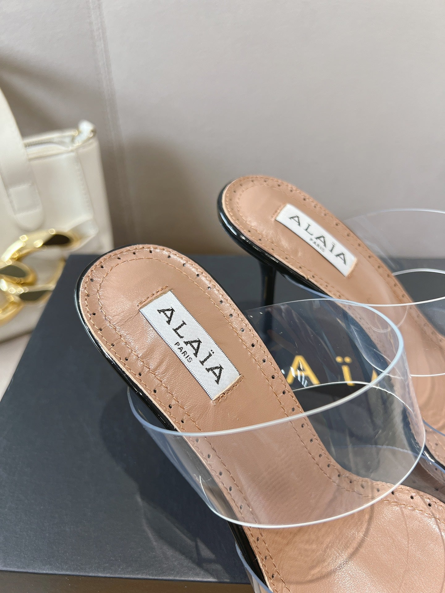ALAIA HIGH MULES IN BLACK PATENT CALFSKIN AND FILM