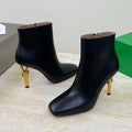 BOTTEGA VENETA KNOT ANKLE BOOT IN BLACK CALFSKIN WITH GOLD METAL HEEL 9 CM