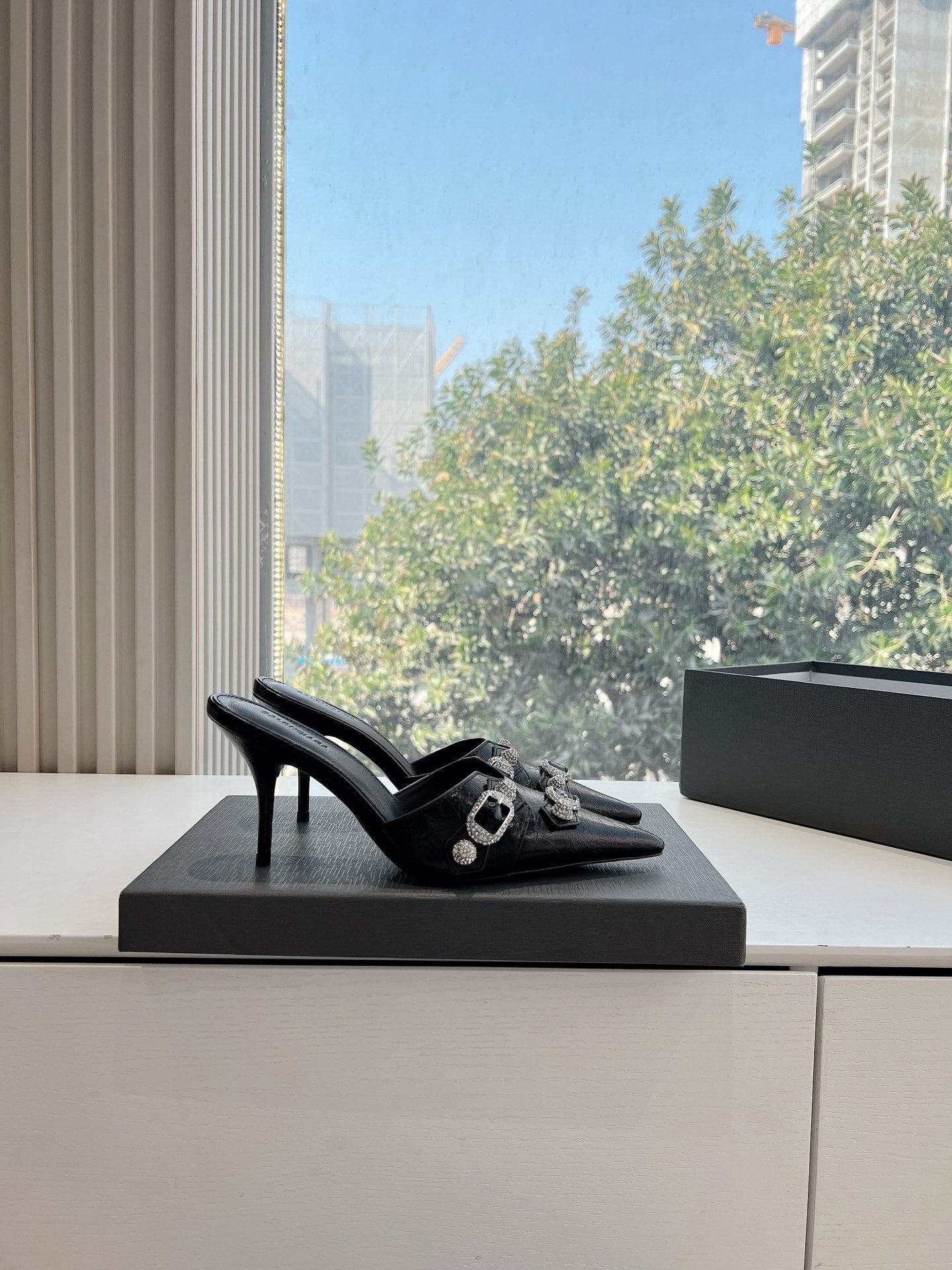 CRYSTAL BUCKLE BLACK WAX-OIL SHEEPSKIN HEELED MULES