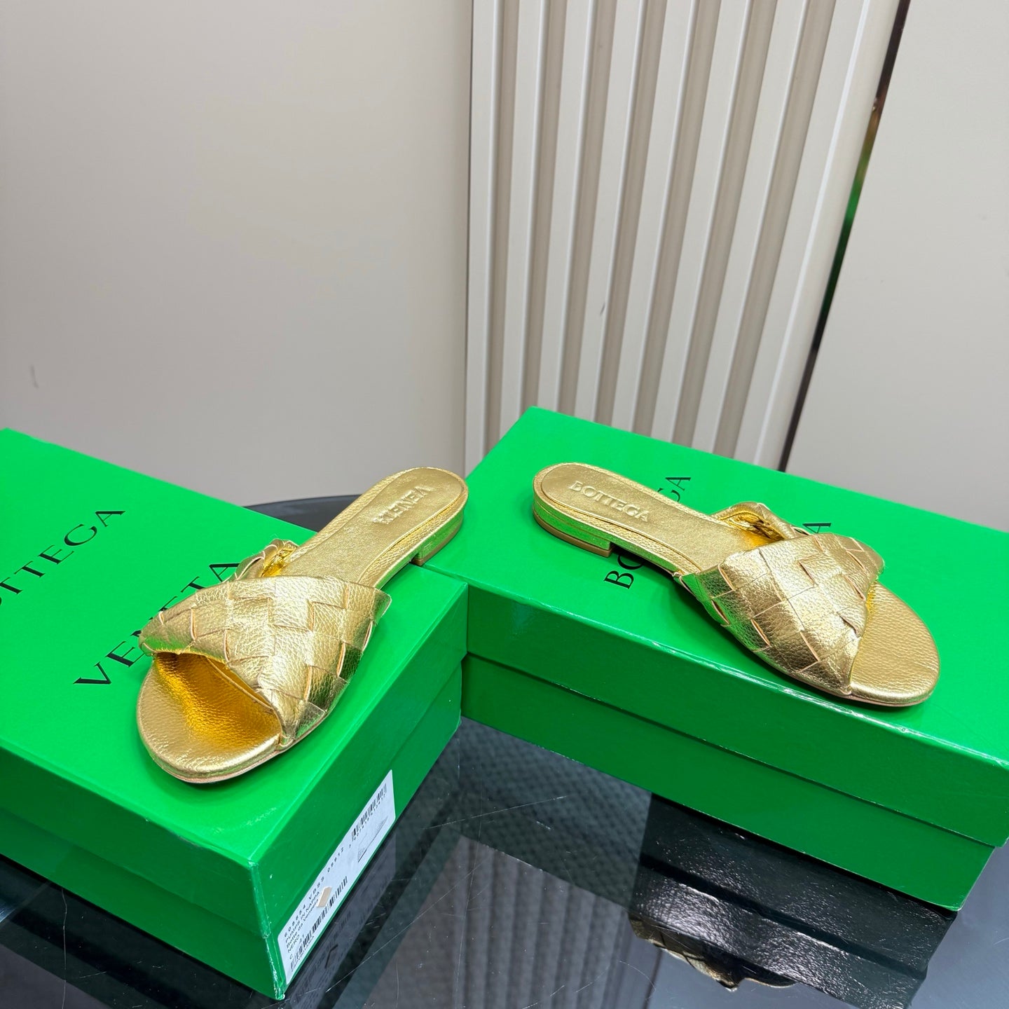 BOTTEGA VENETA BLINK FLAT MULE IN GOLD INTRECCIATO LEATHER