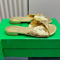 BOTTEGA VENETA BLINK FLAT MULE IN GOLD INTRECCIATO LEATHER